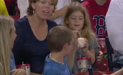 Kind Young Boy Gives Baseball to Girl at a Red Sox Game