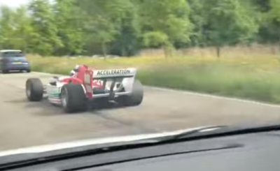 F1 Formula Racecar Driving Through Street Traffic Video