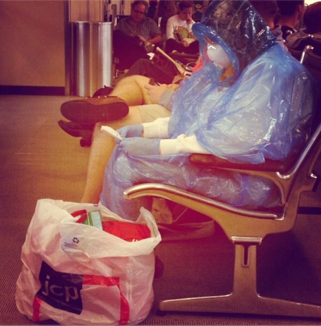 Woman at Dulles Airport Wearing Hazmat Suit for Ebola