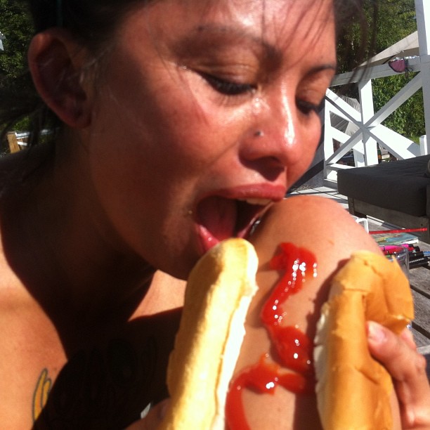 hot dog leg with a bun and ketchup