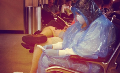 woman at dulles wearing hazmat suit ebola prevention