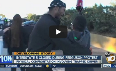 Angry driver pushes student protester on blocked I-5