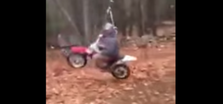 Dad rides a swinging dirt bike attached to a rope 