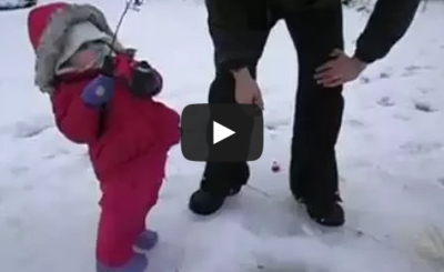 Cute baby girl catches her first fish in Alaska