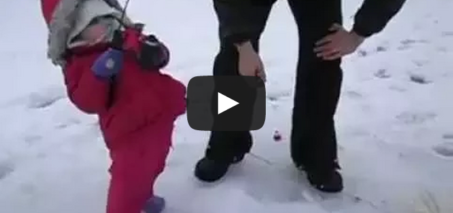 Cute baby girl catches her first fish in Alaska