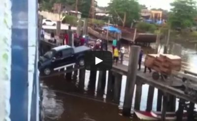 Car boarding a ship over a plank