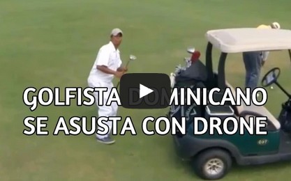 Drone flying on a golf course scares a golfer