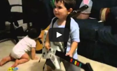 2 year old playing Bulls on Parade on Guitar Hero