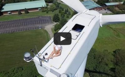 Guy secretly sunbathing on top of wind turbine