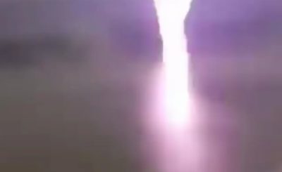 Two guys stand 20m away from a lightning strike, react accordingly.