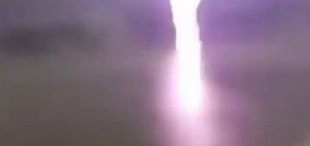 Two guys stand 20m away from a lightning strike, react accordingly.